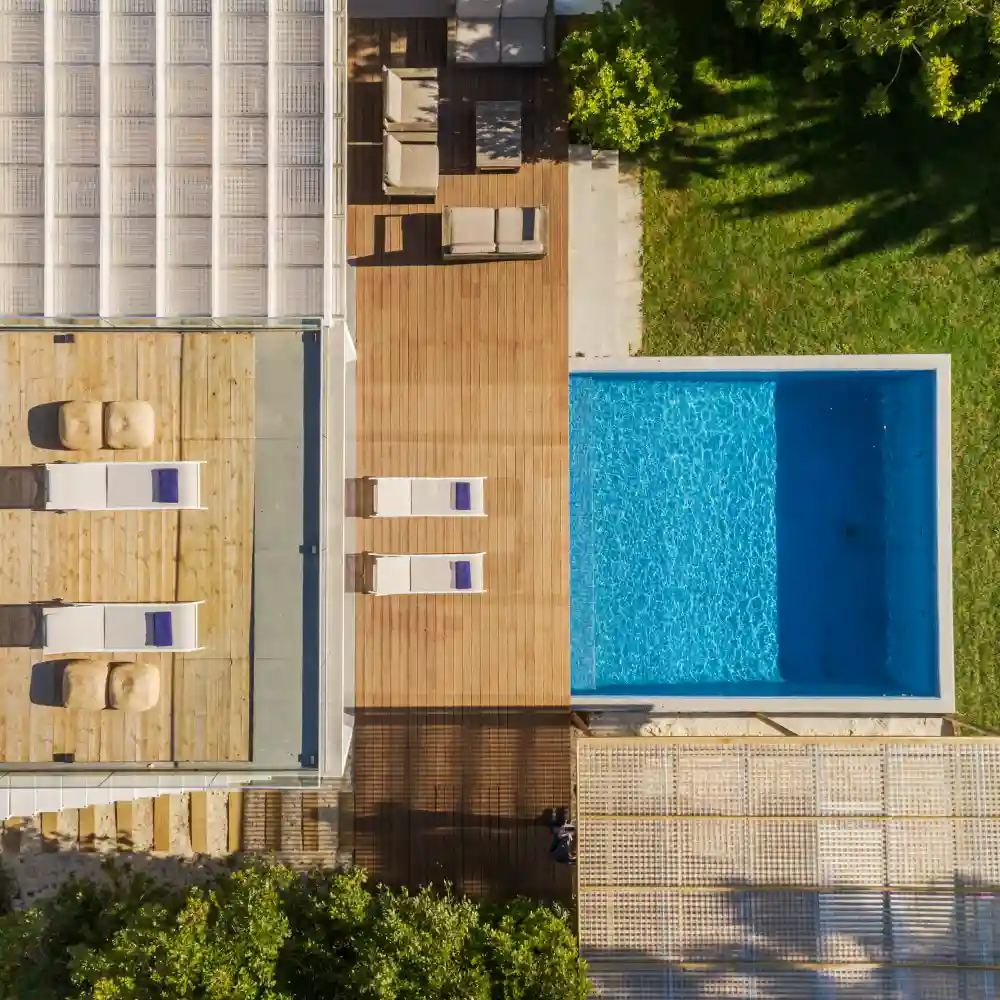 Sunset view of a backyard garden with a swimming pool at a modern villa